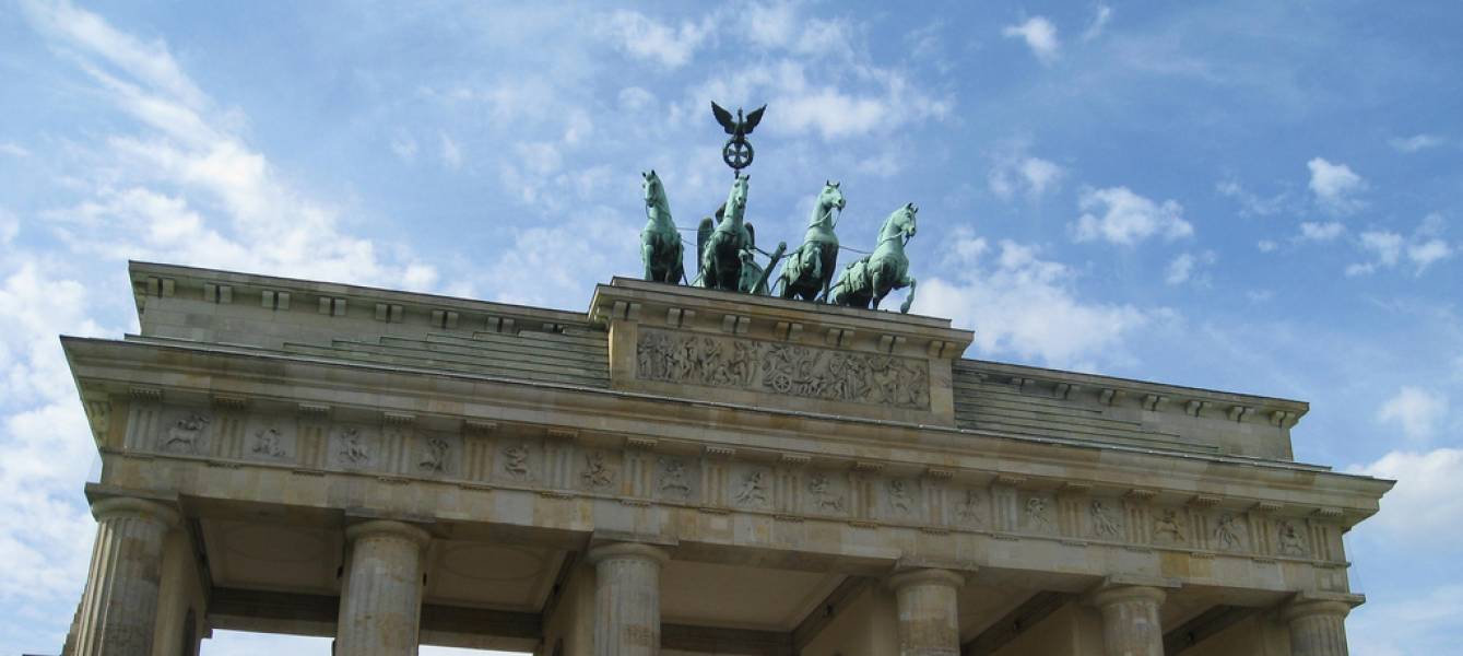 Old roman building with statue on top.